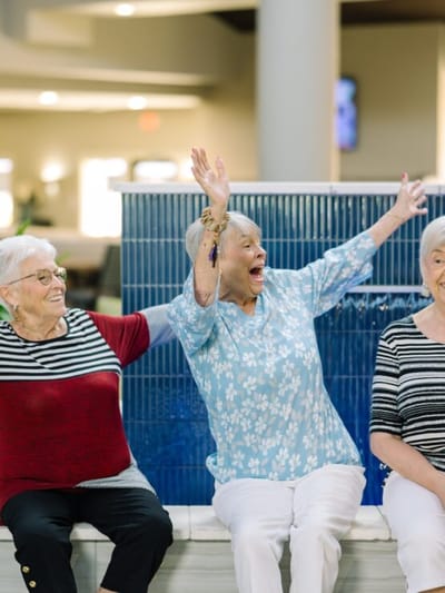 Three residents joyfully celebrating together