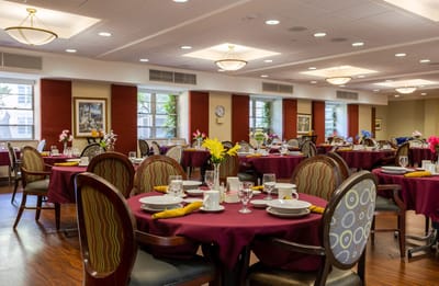 Dining room set up with tables and flowers