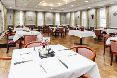 Bright dining room setup with tables and chairs