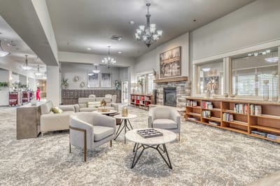 Bright common area with comfortable seating and shelves