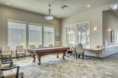 Residents enjoying the common area with a game table