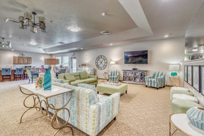 Bright common area with seating and residents.