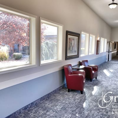 Interior hallway with red chairs and window views