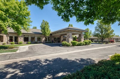 Exterior view of Grace Assisted Living facility with landscaping