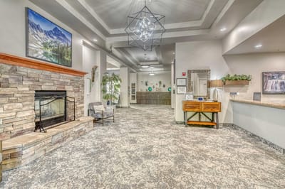 Bright interior common area with seating and a fireplace