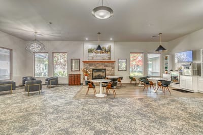 Bright common area with seating and a fireplace