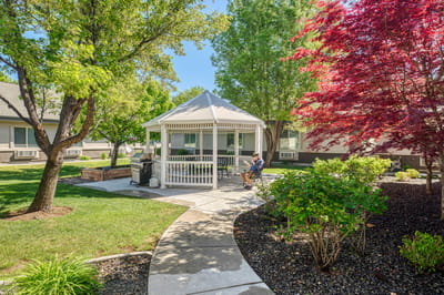Resident relaxing in a gazebo in the garden