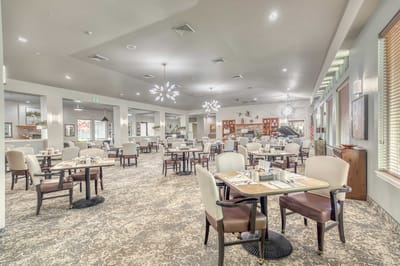 Dining area of a senior living community with tables and chairs