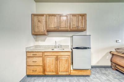 Kitchen area with cabinets and refrigerator