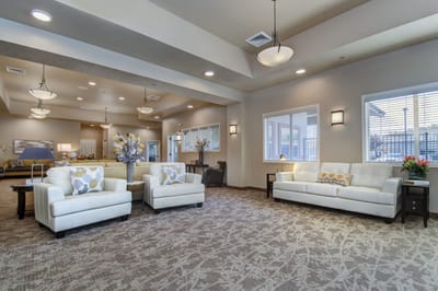 Interior lounge area with white sofas and decor