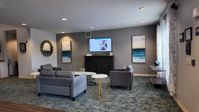 A cozy common area with seating and artwork
