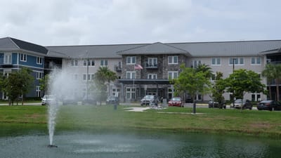 Exterior view of The Landings at Gentry Park with a fountain