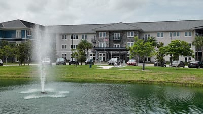 Exterior view of The Landings at Gentry Park with a fountain