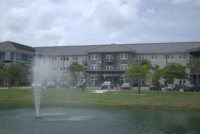 View of the facility building with fountain and lawn