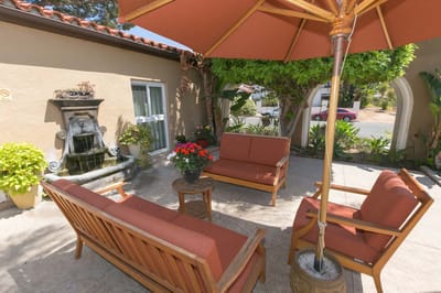 Outdoor seating area with plants and fountain