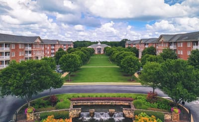 Aerial view of a senior living facility with green landscaping