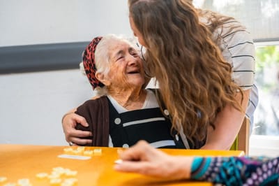 A resident sharing a joyful moment with a staff member