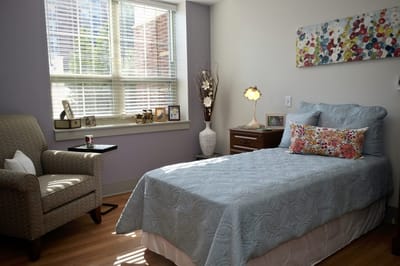 A cozy room setup with a bed and chair