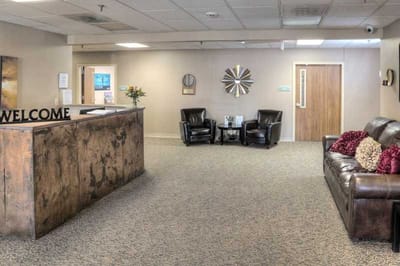 Welcoming reception area with seating and floral arrangements