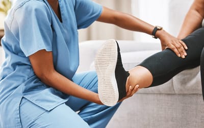 Healthcare professional assisting a resident with mobility