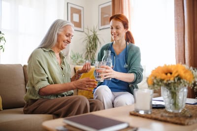 A caregiver and resident sharing a moment in a cozy living area