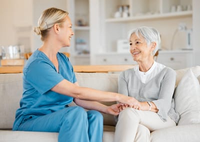 Caregiver interacting with a smiling senior resident