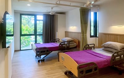 A well-furnished resident room with adjustable beds