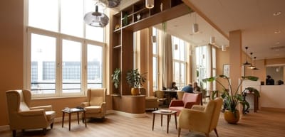 Bright common area with residents in conversation