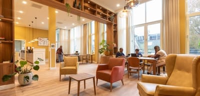 Residents enjoying activities in a bright common area