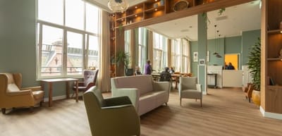 Bright common area with seating and residents