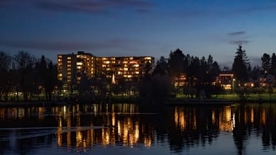 Exterior view of the facility by the lake at night