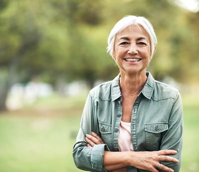 Smiling senior woman in a garden setting