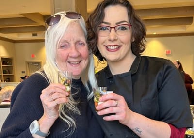 Residents and staff enjoying a social event with drinks