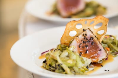 Plated gourmet meal with seared fish and vegetables