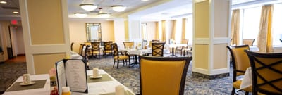Dining area with tables and chairs set for service