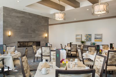 Bright dining room with tables set for meals