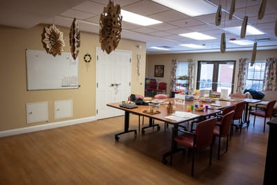 Interior view of an activity room with tables and decorations