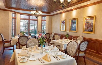 Elegant dining room with tables set for a meal
