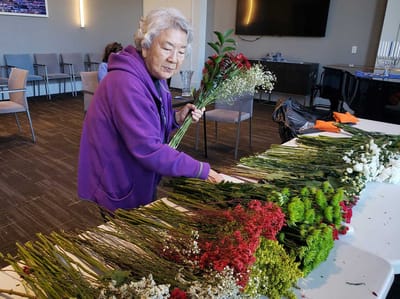 Resident arranging flowers in a common area