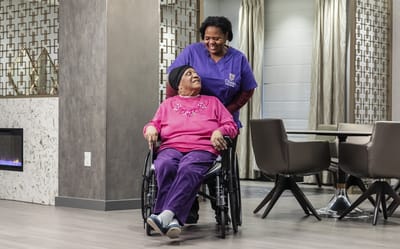 Staff assisting a resident in a common area
