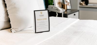 Welcome sign on a neatly made bed in a resident room