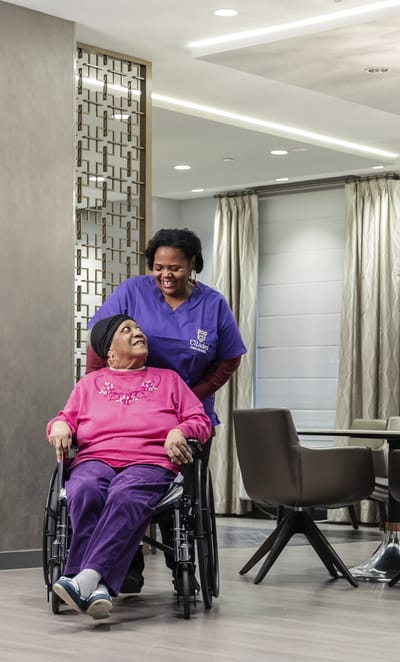 Staff assisting a resident in a common area