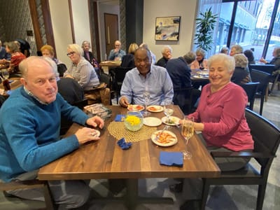 Residents enjoying a meal together in the dining room