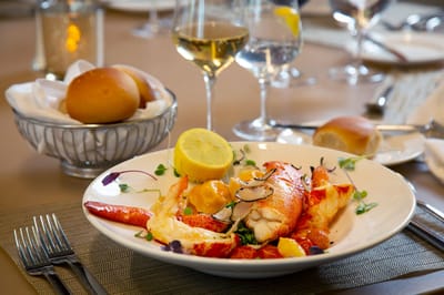 Elegant seafood dish served with wine in dining setting