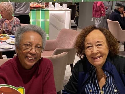 Two residents enjoying a meal together in the dining area