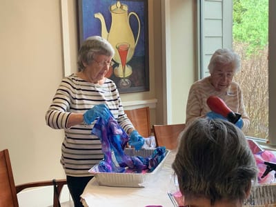 Residents participating in an art activity indoors