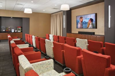 Interior view of a cozy media room with red seating