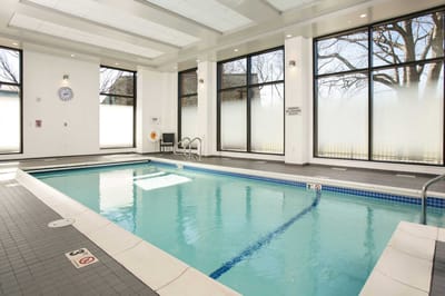 Indoor swimming pool area with large windows