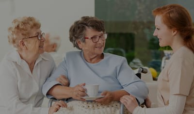 Two residents and a staff member engaged in conversation