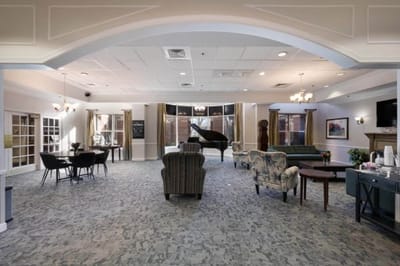 Common area with seating and piano in a senior living community